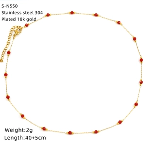 Detail of 18K gold-plated 304 stainless steel chain with faceted red crystal beads