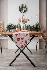 Close-up of Christmas table runner featuring red candy ball prints and triangular tip