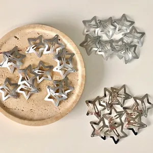 Y2K style silver hollow star metal hair clips in group display on stone tray