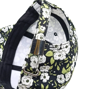 Detail of adjustable silver metal buckle and floral print on women's baseball cap