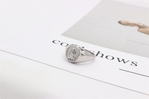 Macro shot of the silver angel cupid relief carving on a wide stainless steel ring