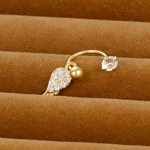 Macro detail of gold-plated piercing ring with micro-pave feather and cubic zirconia