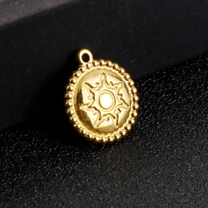 Minimalist gold stainless steel sun pendant necklace with starburst pattern and beaded edge