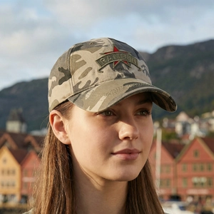 Unisex camouflage baseball cap with Ranger star patch shown on a model outdoors