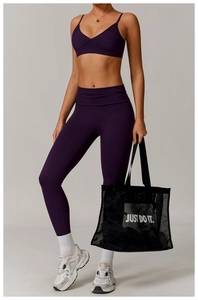 Detail of dark purple high-waist yoga leggings and V-neck sports bra with side stitching