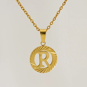 Detail of 18K gold plated stainless steel necklace featuring a letter R round pendant