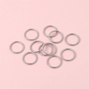 Silver stainless steel open jump rings for DIY jewelry making flat lay on pink background