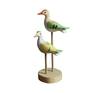 Set of two handcrafted wooden seabird ornaments with rustic hand-painted finish on round bases