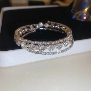 Detail of multi-layered silver flower bracelet with crystals in a premium jewelry box