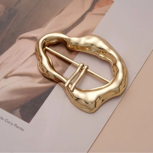 Irregular golden metal belt buckle with a minimalist design for coats and scarves