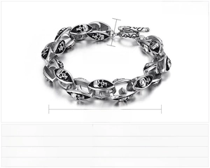 Detail of 13mm stainless steel double skull chain bracelet with T-bar clasp for men