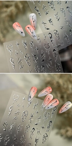 Detail of silver metallic 3D line nail stickers with chrome heart and star patterns