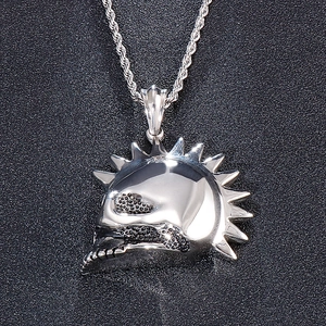 Detailed view of silver skull pendant with spiked mohawk and black textured accents