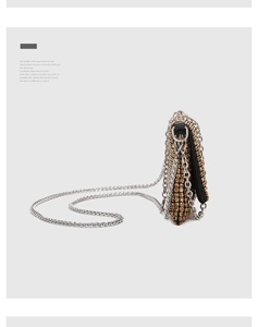 Detail shot of golden rhinestone evening bag with black leather edges and chain strap