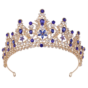 Luxury gold bridal tiara with blue gemstones and sparkling crystals in a floral design