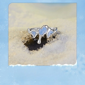 Macro shot of S925 silver snowflake ring with blue enamel and small diamonds on snow