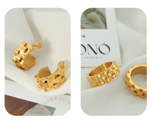 Detail view of gold-plated titanium steel earrings and ring set with gear texture design