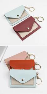 Detail view of colorful PU leather card holders with metal snaps and keychains