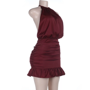 Detail view of burgundy satin halter dress with side ruching and ruffle hem detail