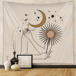 Detail of bohemian tapestry featuring minimalist line art with moon and sun celestial motifs