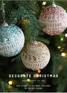 Detail of 8cm glitter Christmas foam balls with lace patterns hanging on a tree