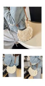Close-up of semi-circular woven shoulder bag with floral lace edging and leather strap