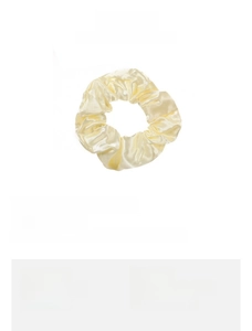 Detail view of light yellow satin scrunchie with 4cm inner diameter and 3.5cm width