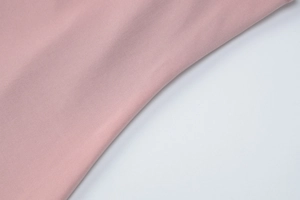 Close-up of pink twill fabric texture for the summer backless sleeveless dress