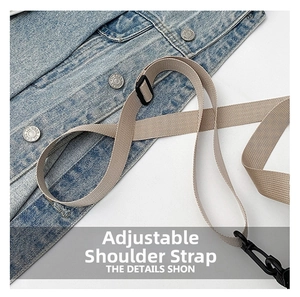 Close-up of adjustable beige woven shoulder strap with black hardware on denim jacket