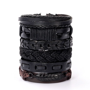 Detailed view of multilayer leather bracelets with feather pendant and woven patterns