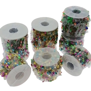 Colorful light bulb shaped Christmas bead string decorations on white plastic spools
