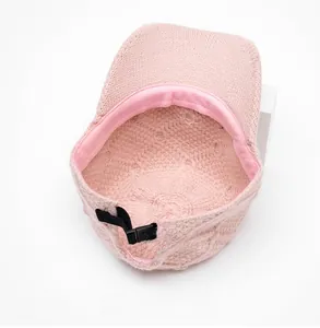 Detailed interior of pink knit baseball cap featuring adjustable strap and sweatband