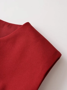 Detailed close-up of dark red woven fabric showing premium twill texture and belt detail