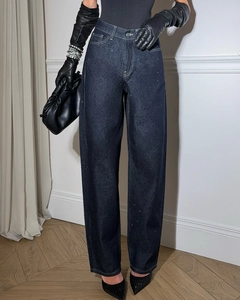 Gros plan d'un jean taille haute bleu foncé avec des ornements en strass étincelants