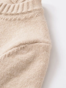 Close-up of premium oatmeal knit sweater collar showing fine stitching and soft texture