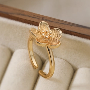 18K gold-plated plum blossom open ring with brushed petals in a beige velvet box
