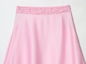 Detailed view of pink satin skirt with delicate lace waistband and soft glossy texture