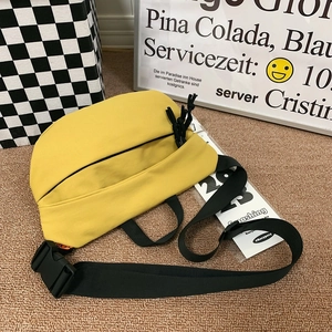 Minimalist bright yellow waterproof crossbody chest bag with adjustable black shoulder strap