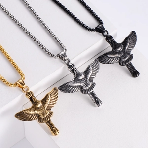 Titanium eagle pendant necklaces in gold, silver, and black on geometric pedestals