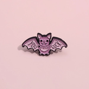 Creative purple bat enamel pin featuring black metal edges and YOU SUCK text engraving