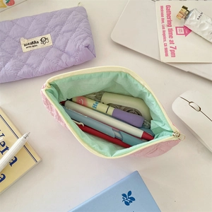 Detailed close-up of macaron quilted stationery bag with contrasting mint green lining