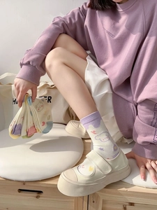 Detail of cute pastel cartoon socks featuring soft cotton texture and heart bear patterns