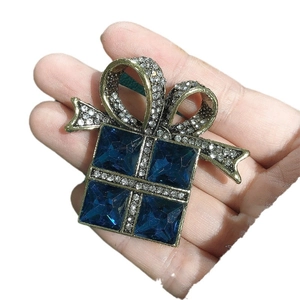 Vintage gold gift box brooch with blue rhinestones and sparkling crystal bow ribbon