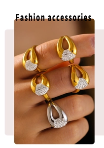 Close-up of geometric 18k gold plated rings with diamonds on a model hand