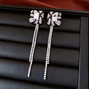 Macro view of vintage square tassel earrings with black enamel and sparkling rhinestones