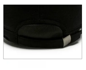 Detail of adjustable metal buckle and strap on the back of the black winter cap