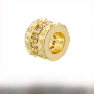 Macro shot of 5x8mm gold honeycomb bead with wavy texture and white zircon inlay