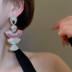 Detail of fan-shaped silver needle earring with pink and purple inlaid crystals