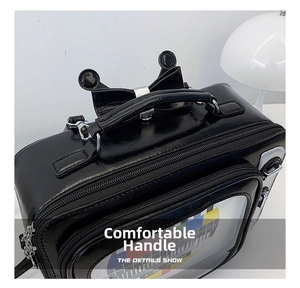 Detail view of the comfortable top handle and sturdy metal zipper on this retro TV crossbody bag