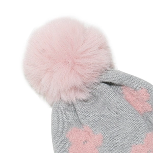 Detail of grey knitted hat featuring pink jacquard patterns and a soft faux fur pompom